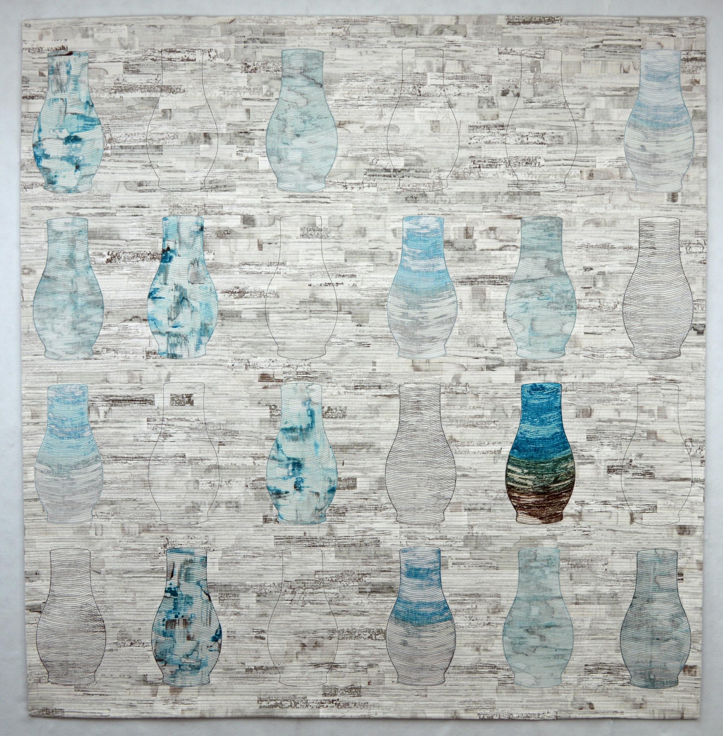 Image depicts a patchwork quilt with a greyscale colour background and repeated motifs of a vase in shades of blue.