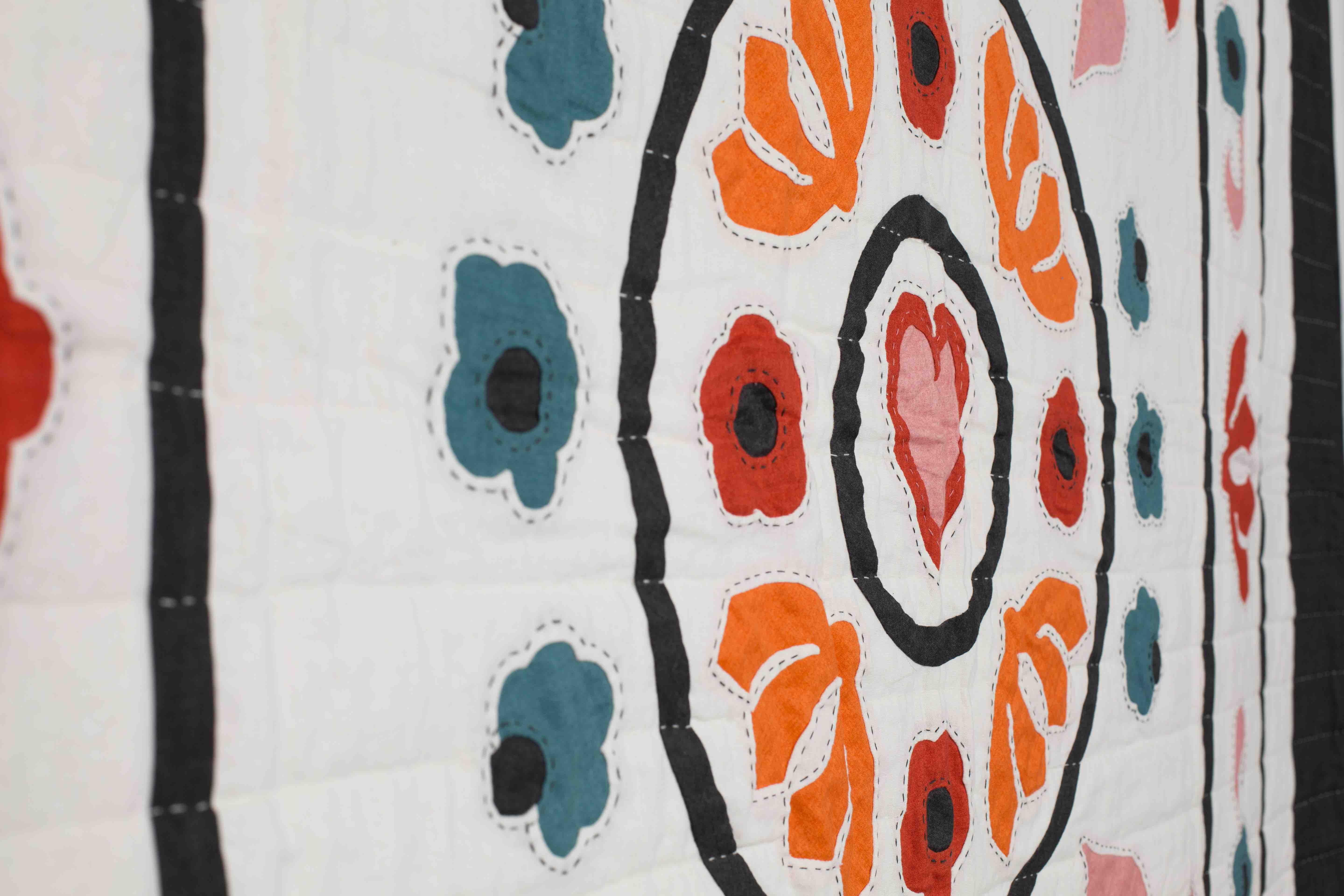 Garden Festival quilt by Karen Lewis inspired by the Ladies Work Society heritage quilt, featuring appliqué floral and paisley motifs