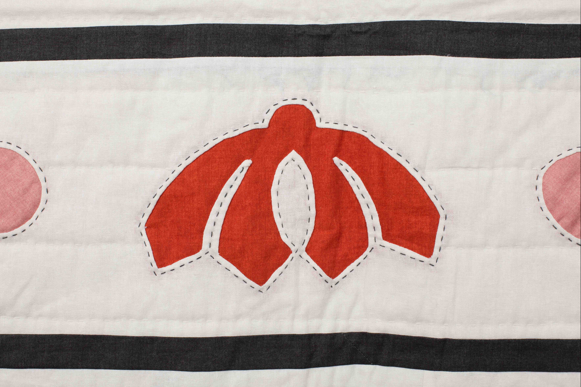 Close-up of appliqué quilt blocks in the Garden Festival pattern showing floral and paisley shapes
