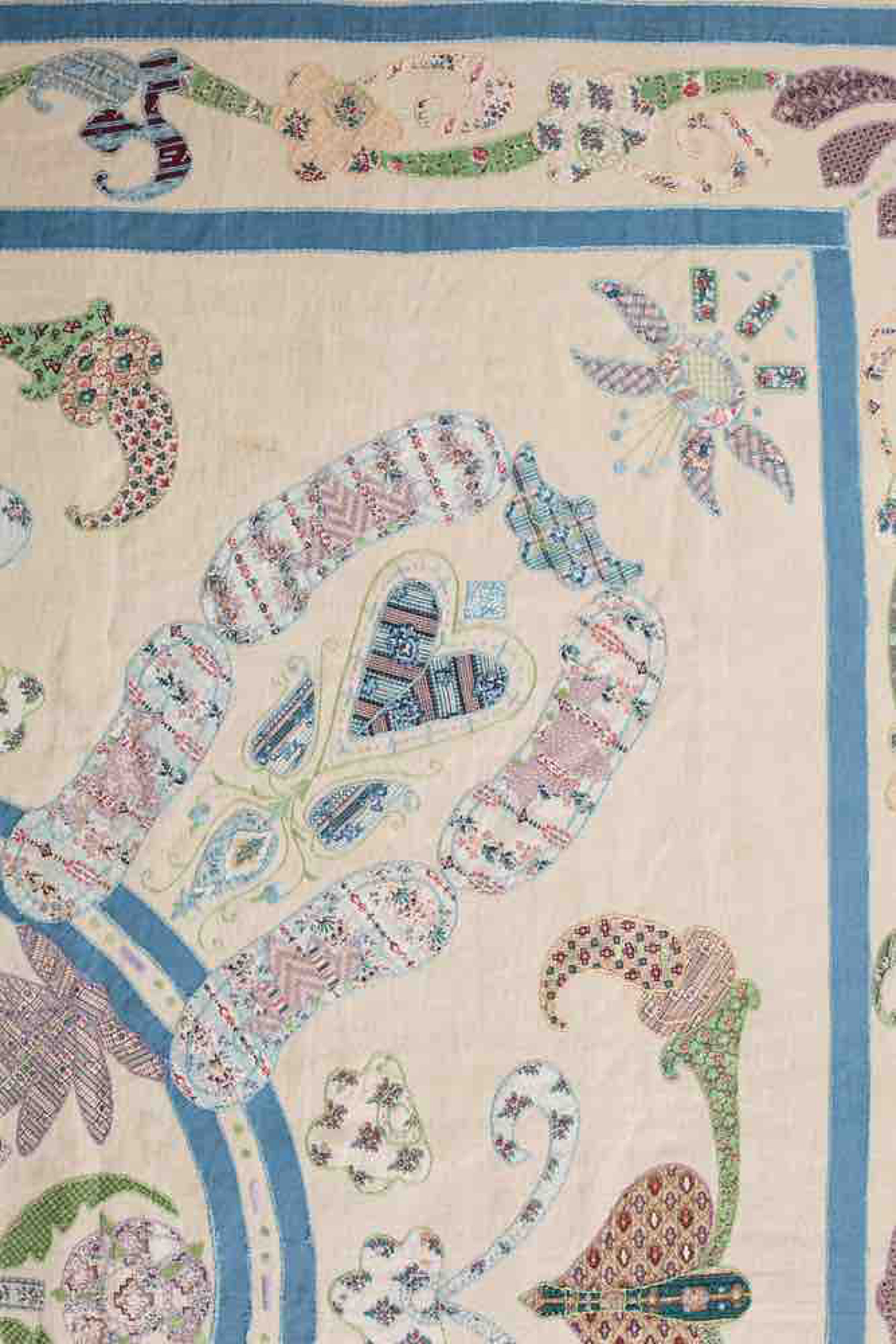 Quilt detail showing hand-finished appliqué and embroidery in a 19th century heritage quilt
