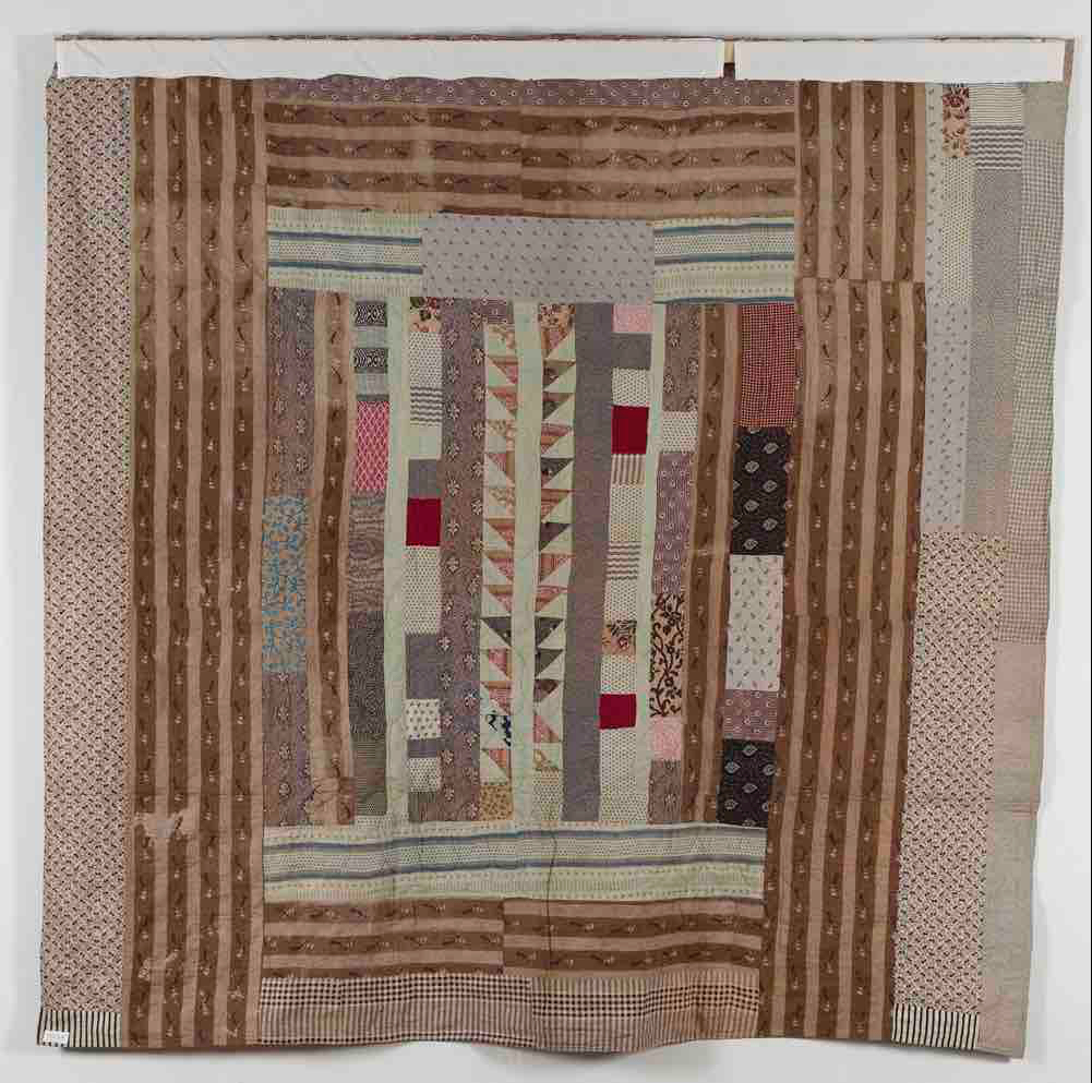 Reverse of Agnes Bentham coverlet showing strippy patchwork design with central triangle row