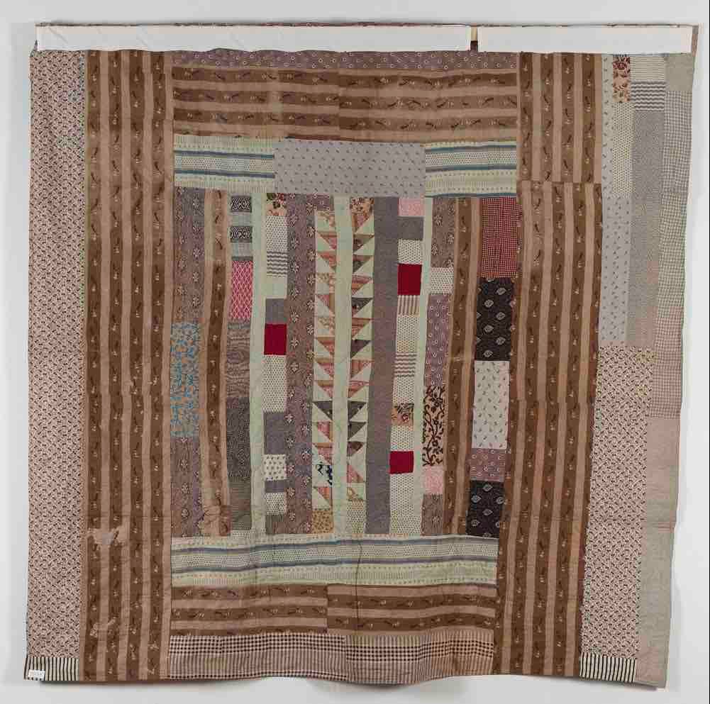 Reverse of Agnes Bentham coverlet showing strippy patchwork design with central triangle row