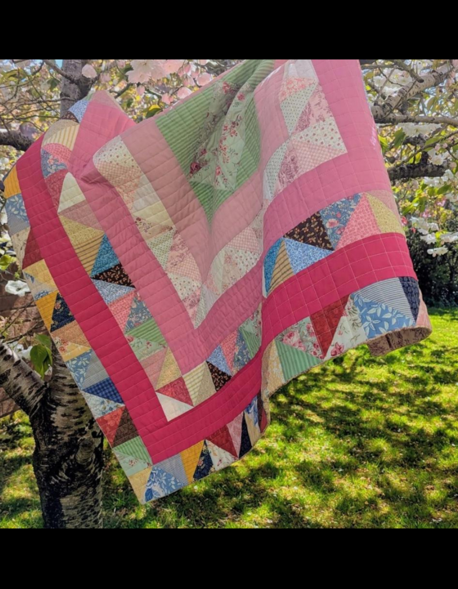 Modern Cumbrian frame quilt inspired by Bertha Mitchell&rsquo;s 1899 design, made with bright colours and floral fabrics