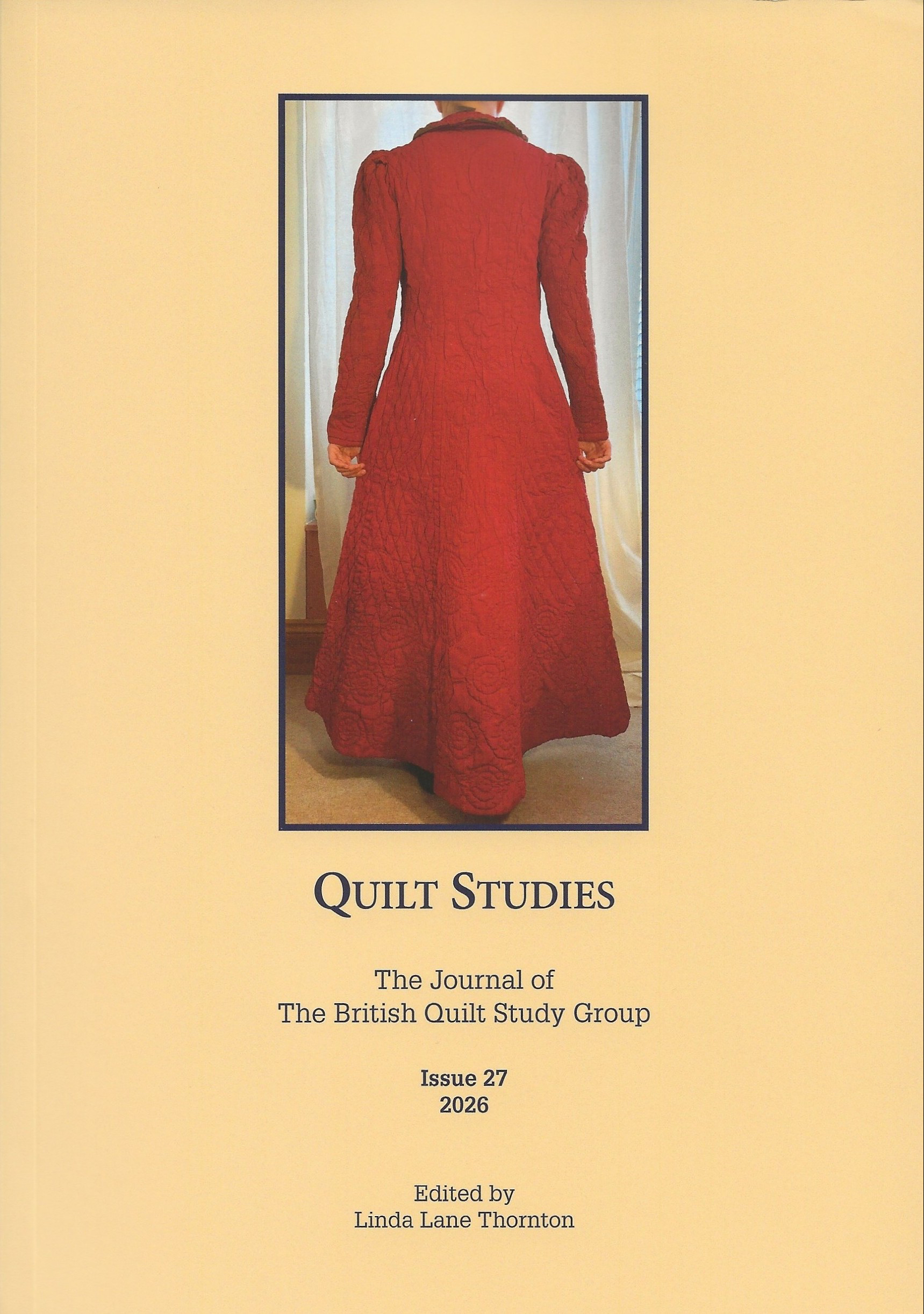Front cover of Quilt Studies Issue 27 featuring a long red quilted dress and the title The Journal of The British Quilt Study Group