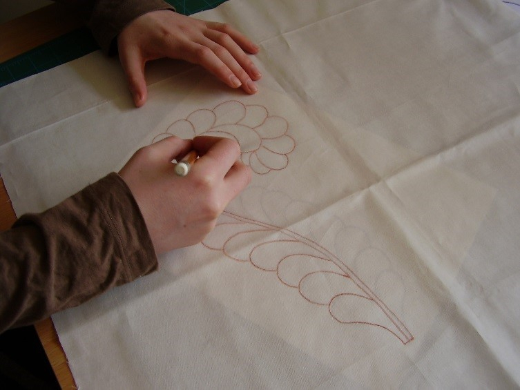 Person drawing wholecloth pattern