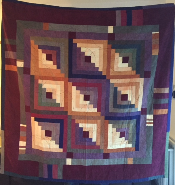 Multicoloured log cabin style quilt