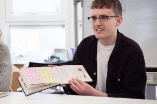 Student looking through notebook