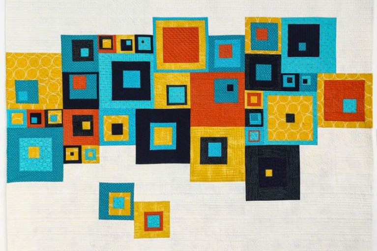 Total Square by Sarah Humphreys: Quilt with beige background and turquoise, orange, yellow and black squares