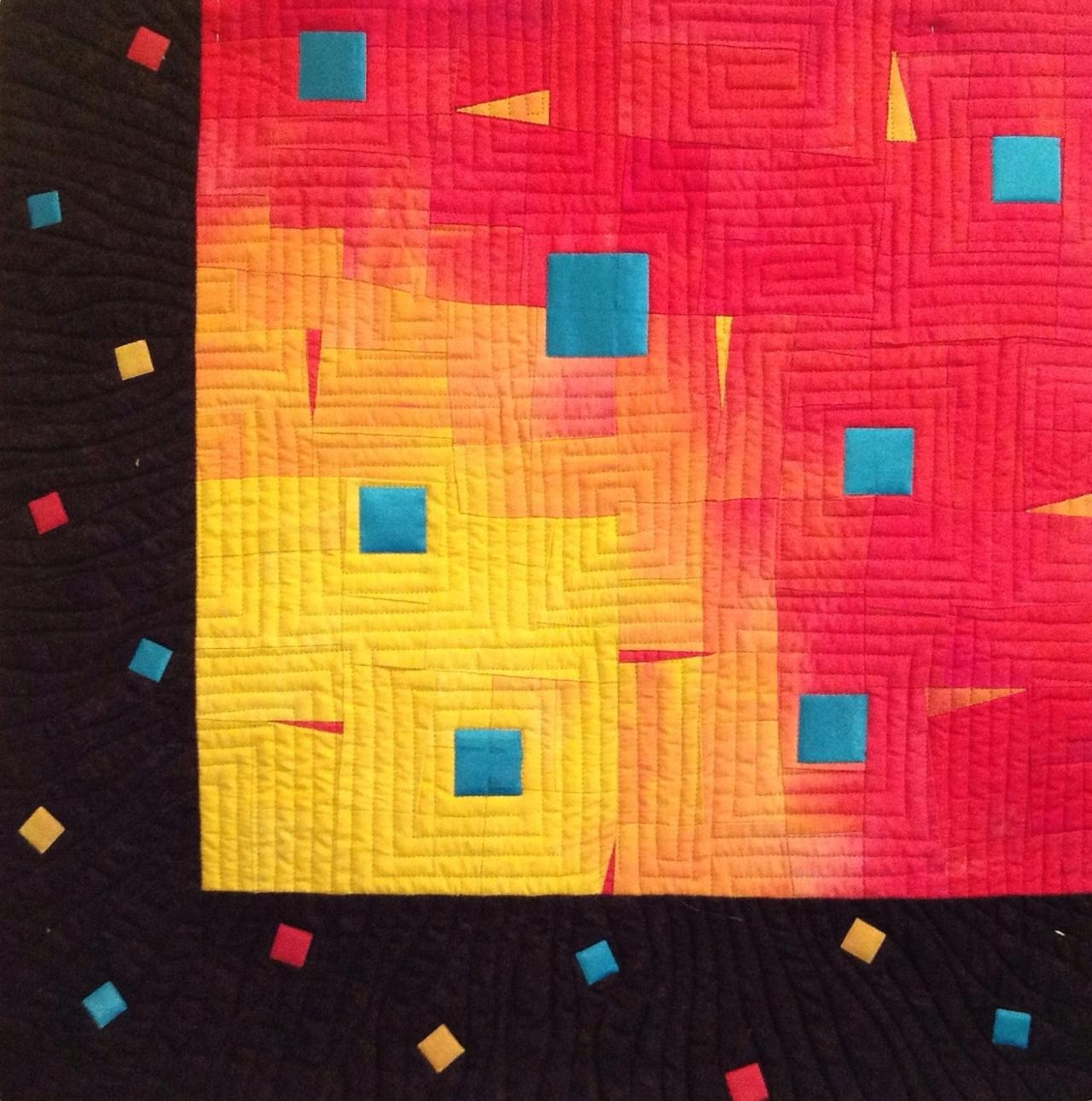 Razzle by Linda Bilsborrow: Quilt with colour gradient changing from yellow to red from bottom left corner with black border