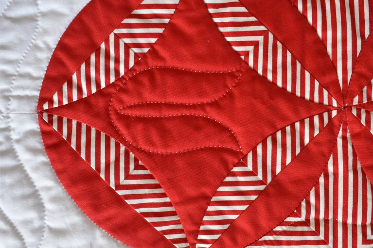 Close up of The Burglar by Carolyn Gibbs: white background with a red and white pattern