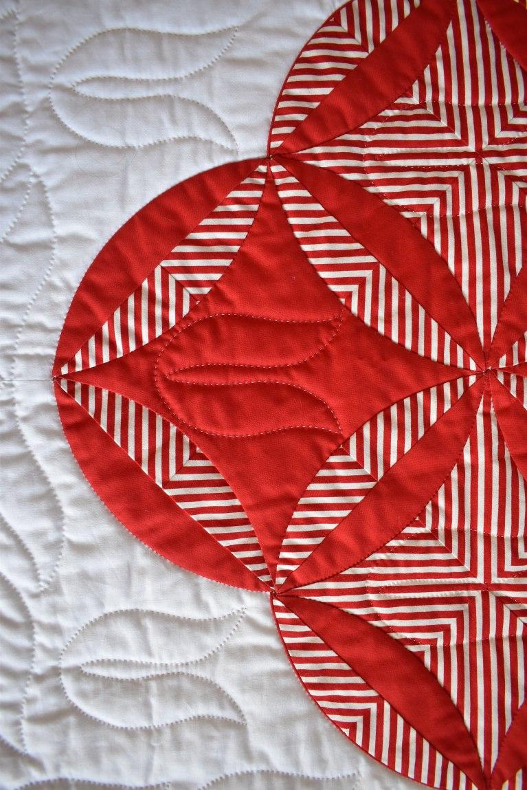 Close up of The Burglar by Carolyn Gibbs: white background with a red and white pattern