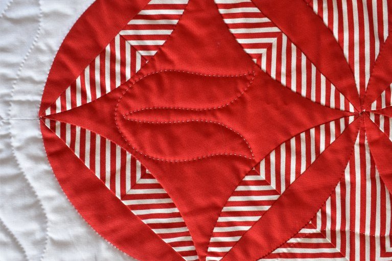 Close up of The Burglar by Carolyn Gibbs: white background with a red and white pattern