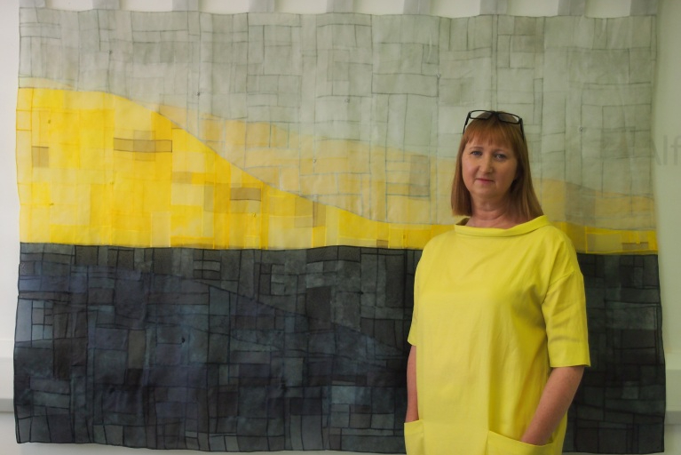 Sara Cook with her quilt The Greyline
