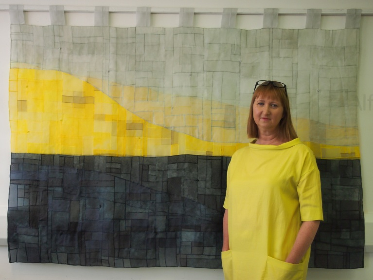 Sara Cook with her quilt The Greyline