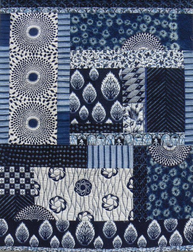 African Odyssey 2 by Janice Gunner: Quilted piece made of multiple different blue and white fabrics with nature patterns on, in different sized rectangle and square pieces 
