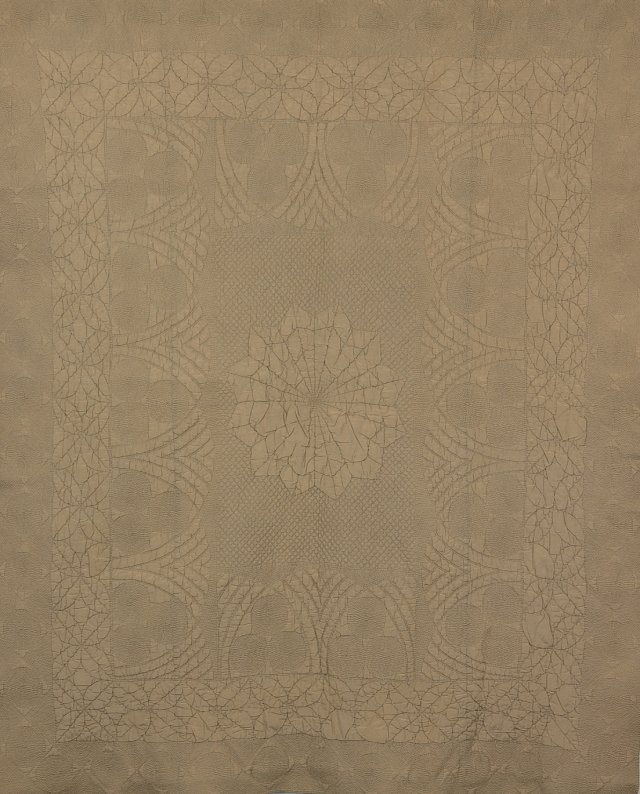Cream quilt with a centre and defined borders layout, with a signature Art Deco lotus leaf motif.