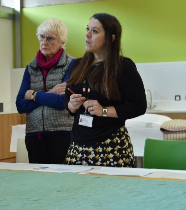 Elen Phillips, Curator at St Fagans National Museum of History showing BQSG members items from their quilt collection.