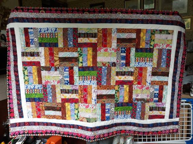 Multi-coloured patchwork quilt made of narrow rectangular blocks
