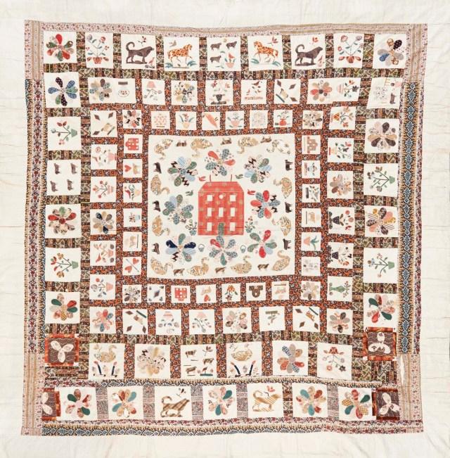 Red Manor House Coverlet: A frame quilt, with a central motif of a red house surrounded by flowers, and domestic and rural animals