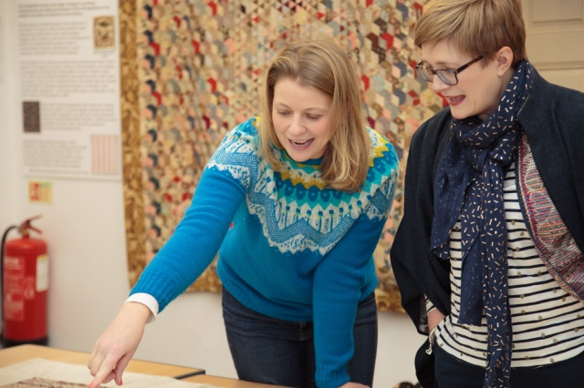 Jenni Smith and Kay Walsh studying the Red Manor House Coverlet