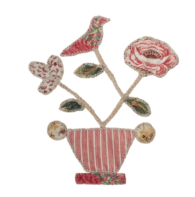 Flower made of fabric with a bird sat on top, on a white background