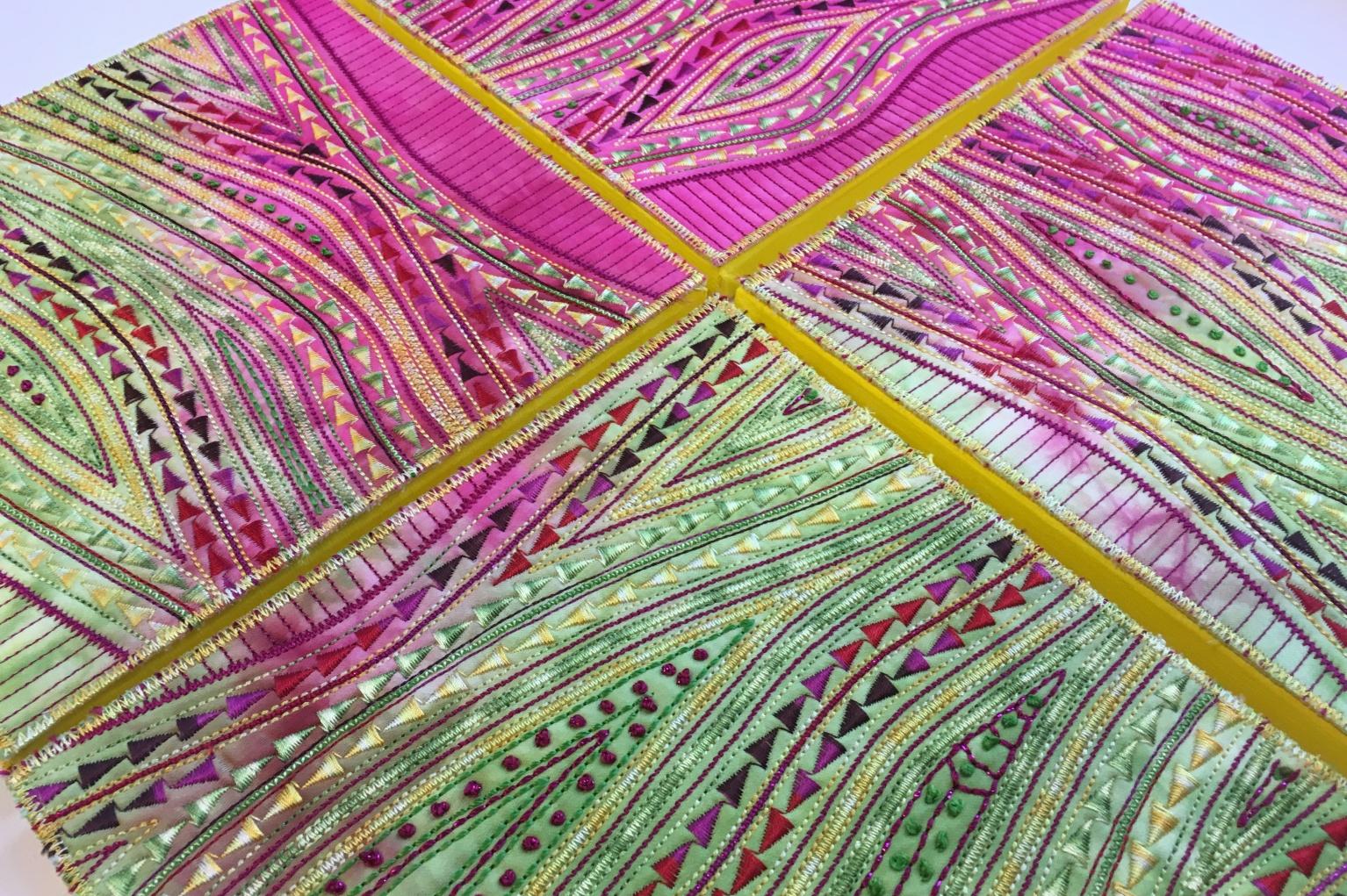 Pink and Green patterned stitching with a yellow cross in the middle