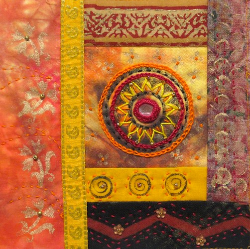 Orange, yellow, brown and gold fabric displaying multiple stitching types