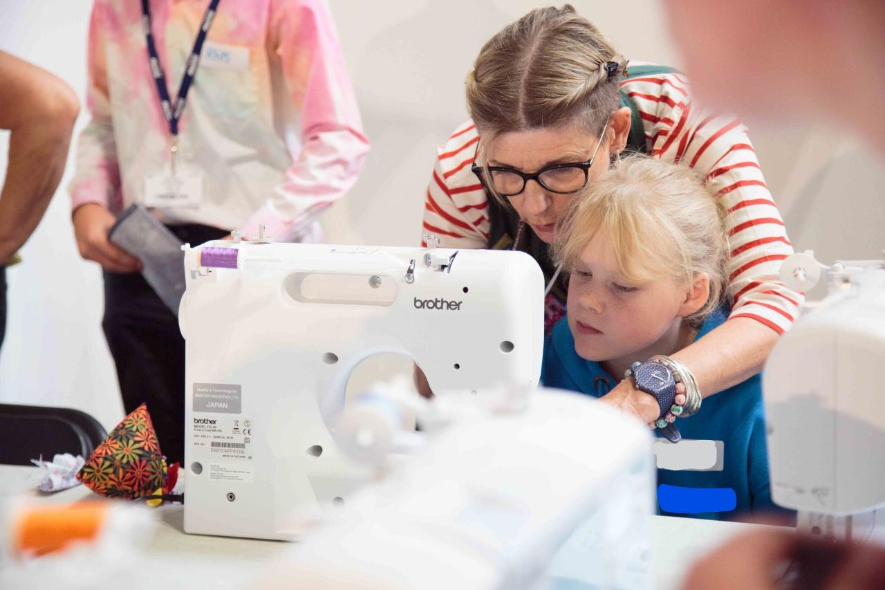 An adult helping a child use a sewing machine