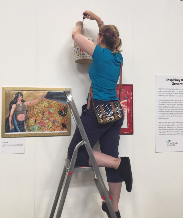 Hanging the York St. John University students? collaborative exhibition inspired by the Red Manor House Coverlet at The Festival of Quilts 2019