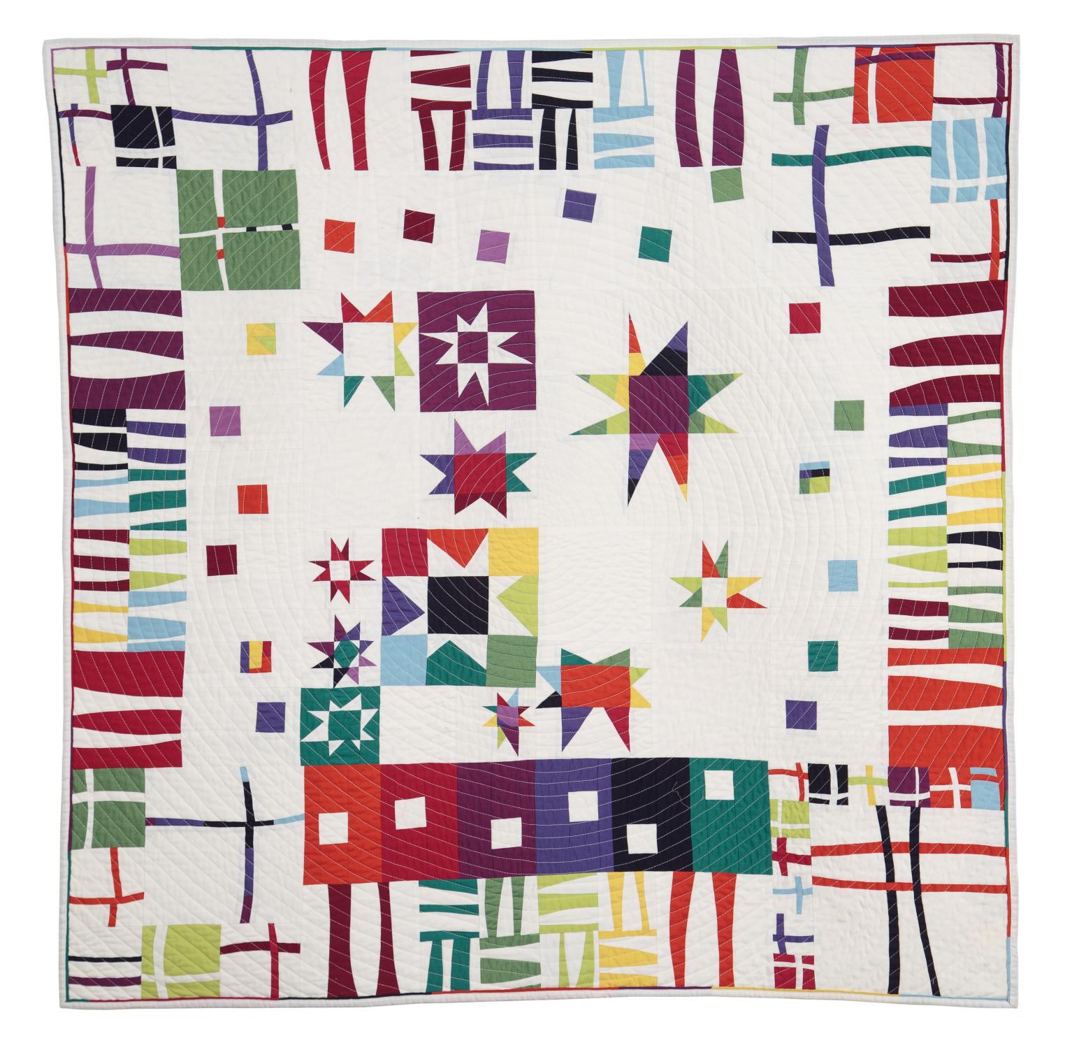 Beige quilt with rainbow coloured pattern in triangles, rectangles and squares