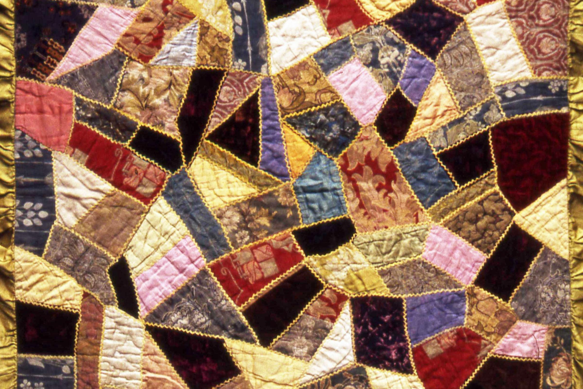quilt in multiple colours, contrasting fabrics and shapes