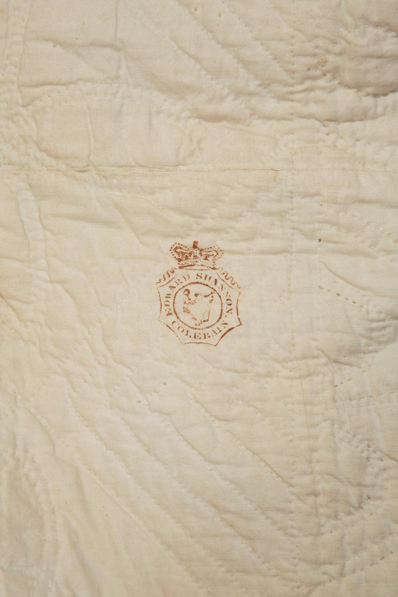 Rear of quilt that features the printed stamp of the Irish Linen maker ?Edward Shannon, Colerain?
