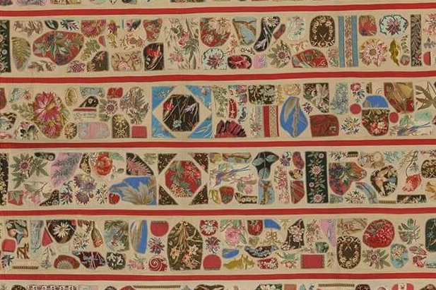 Applique quilt in gold and red