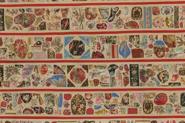 Applique quilt in gold and red