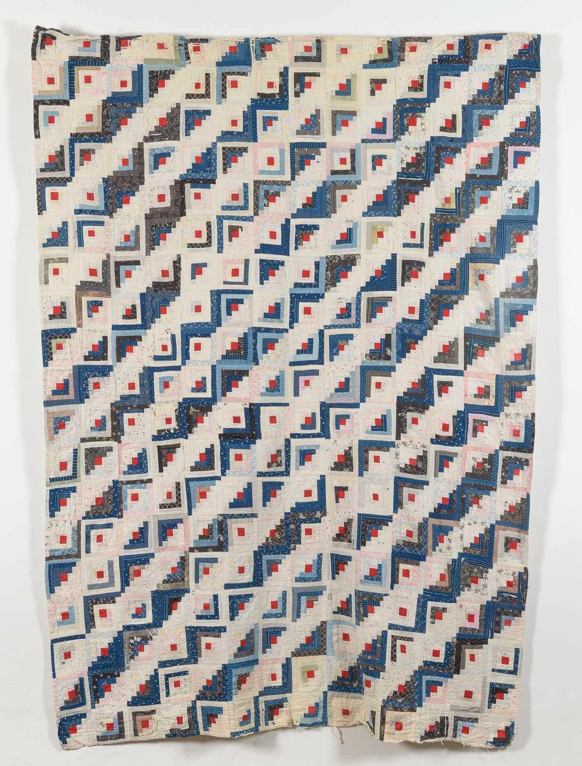 Quilt in blue and red with diagonal bands of white