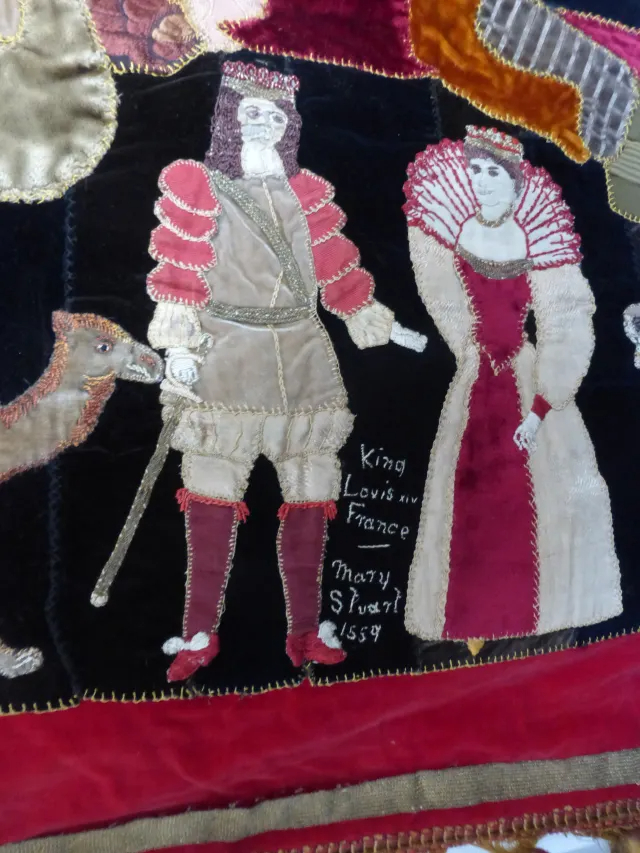 Appliqué figures decorating a quilt.