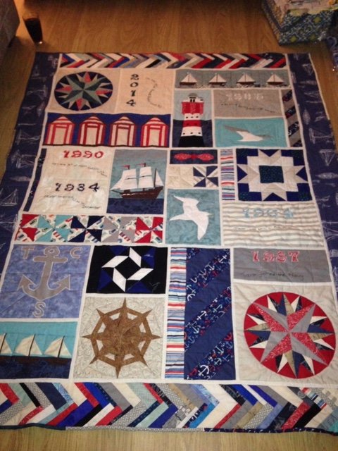 Nautical themed sampler quilt in blues, reds and creams.