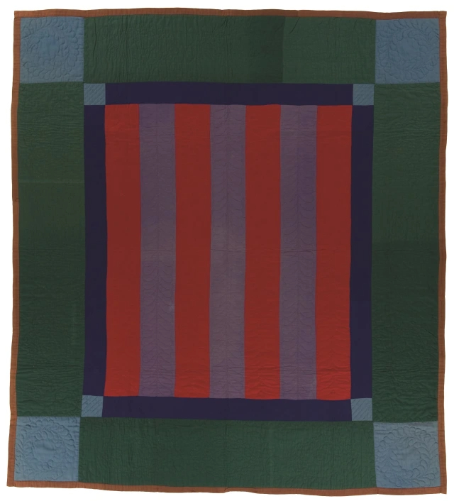 Rectangular quilt with wide dark green border, light blue squares at each corner. The centre design is made of a navy blue border with light blue corners with red and purple alternating stripes in the middle.