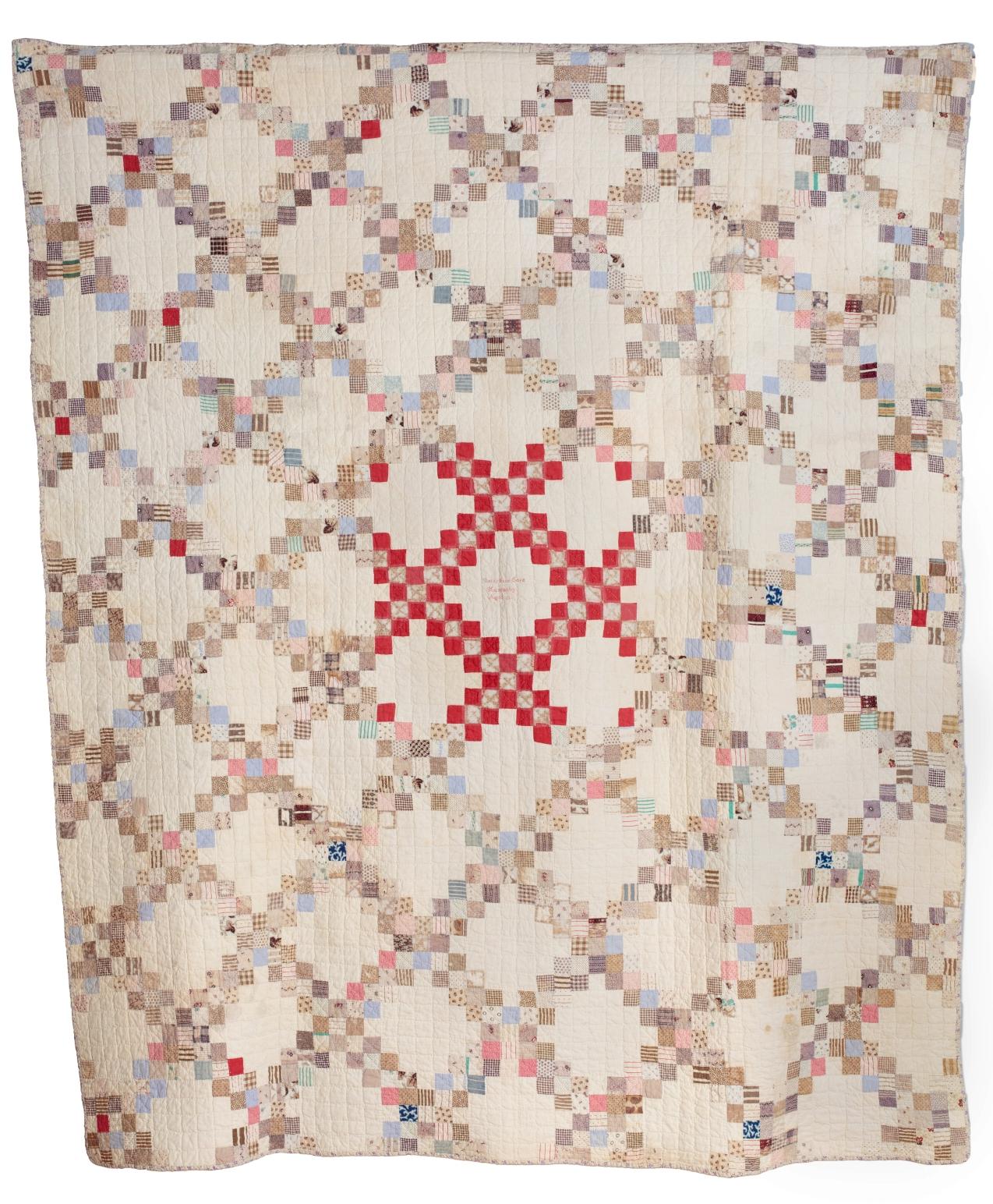 Betsy Cope Quilt: Large double Irish Chain patchwork quilt. Multiple small squares in patterned fabric arranged in a diamond pattern with white background. With a centre square made of red and white small squares