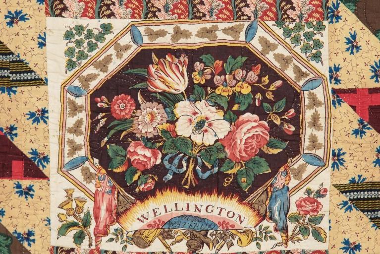 Quilt with floral design and the words Wellington and Waterloo in the centre