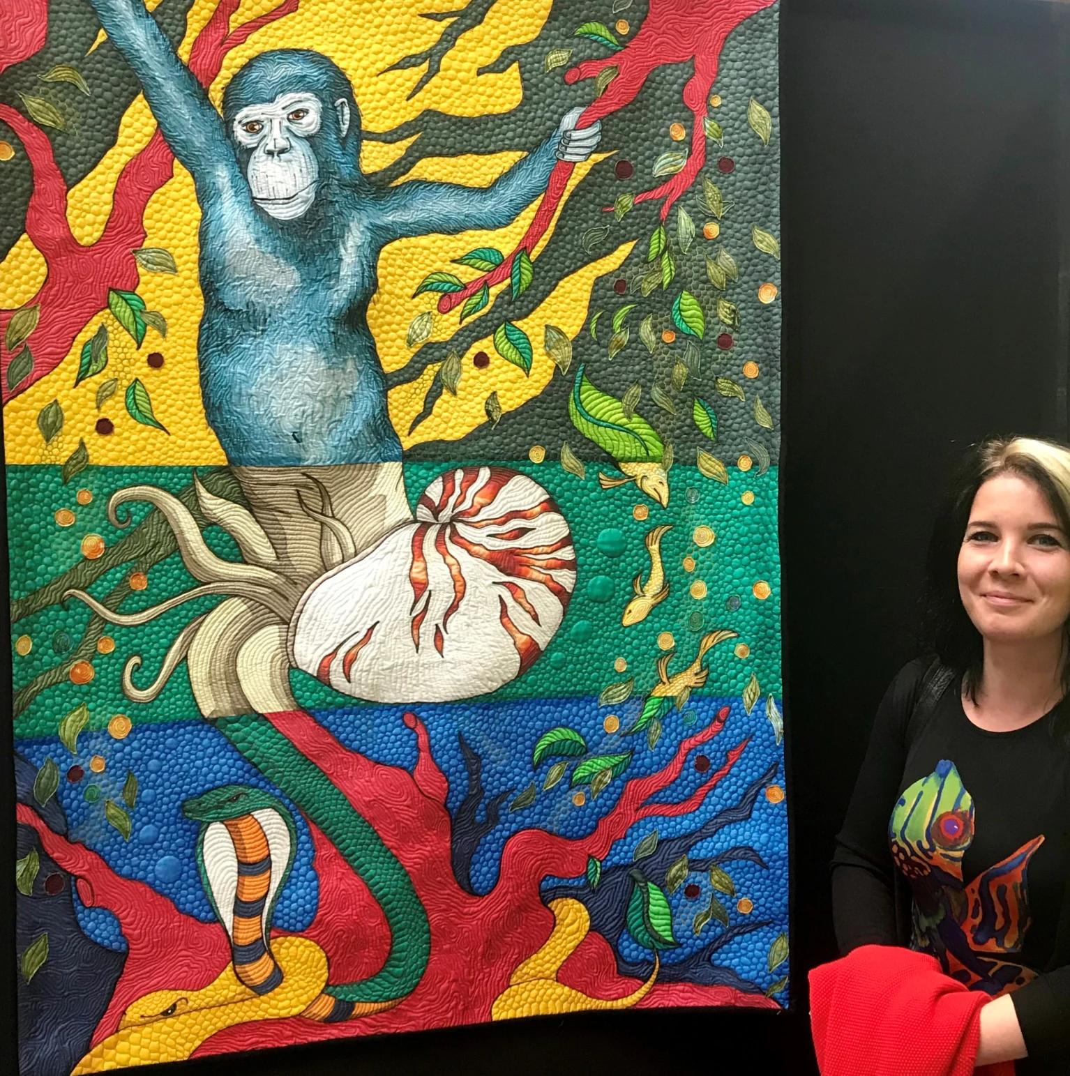 Pascale Michalski stood next to one of her quilts on display