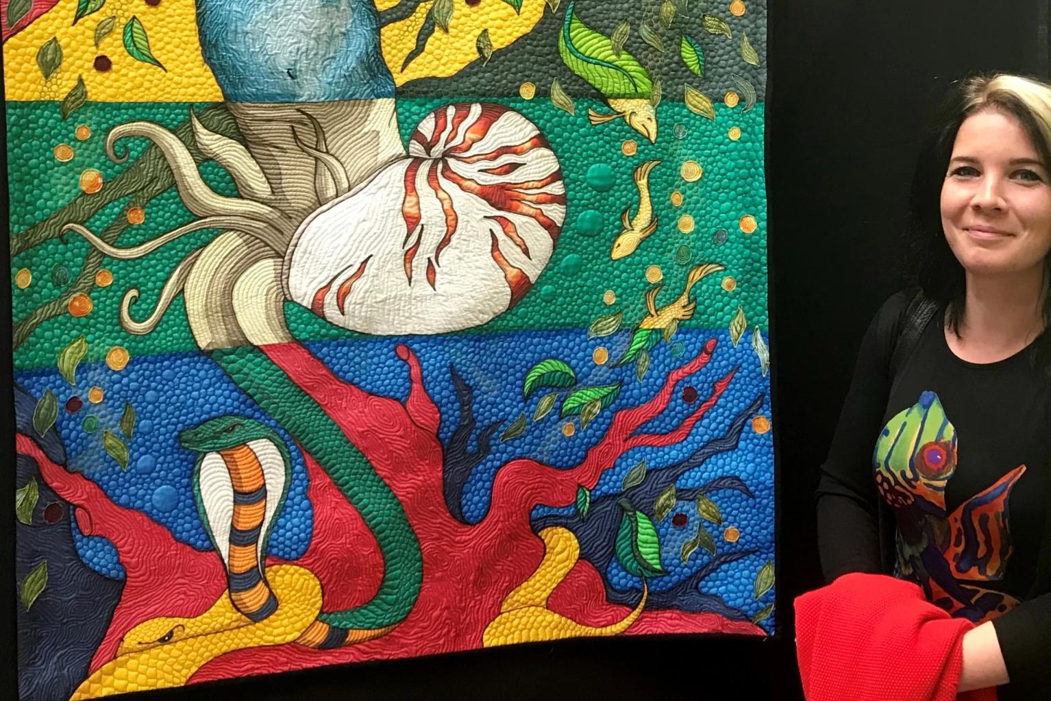 Pascale Michalski stood next to one of her quilts on display