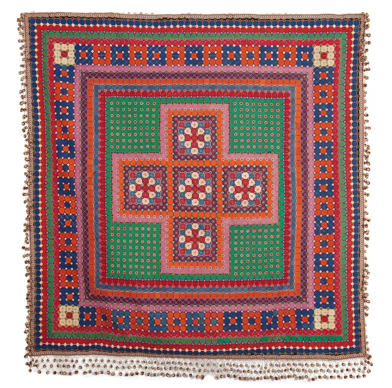 Uncle Tom's Patchwork Coverlet: Orange pink and red cross design with green background and patterned border with tassles