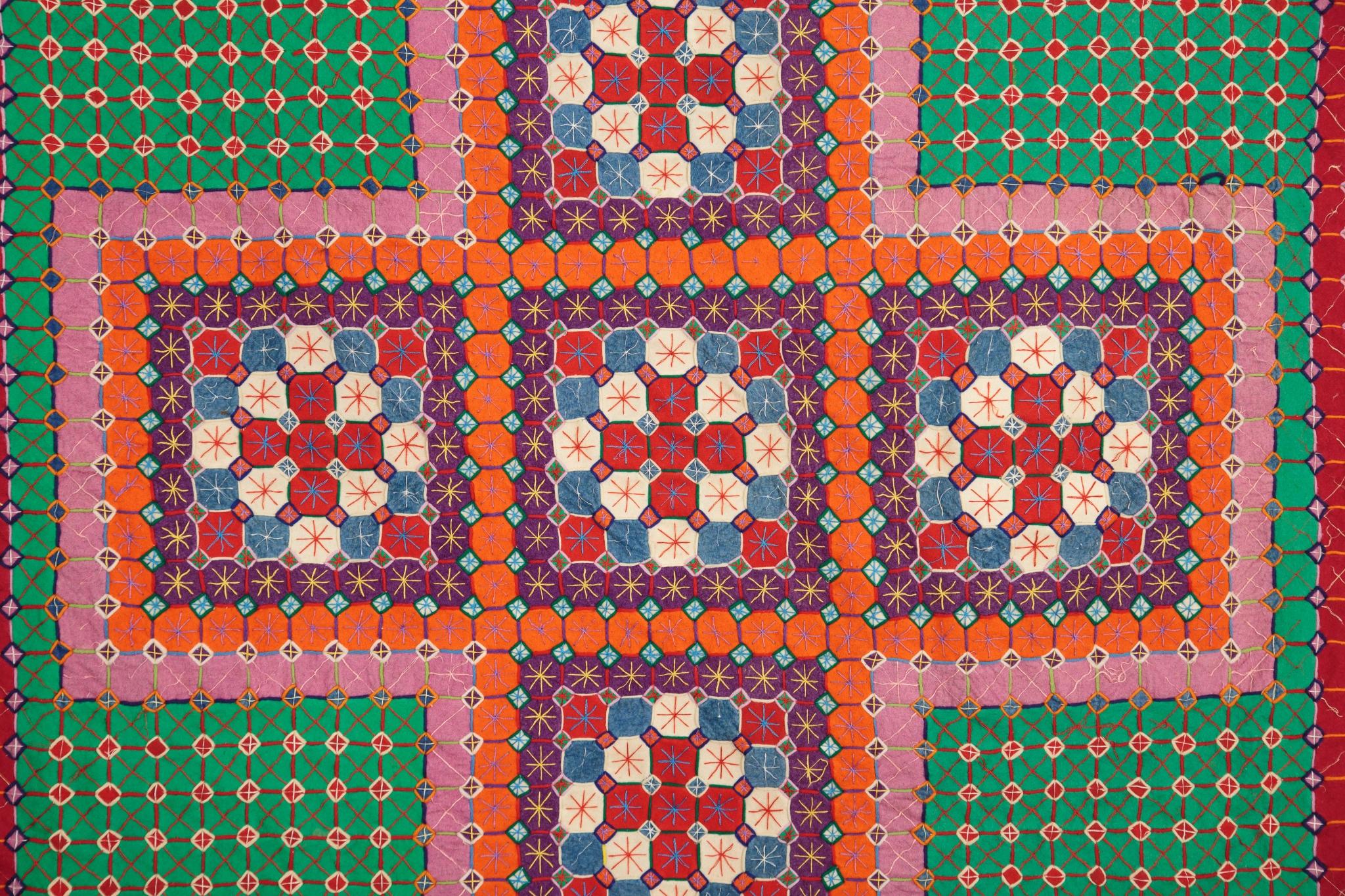 Close up image showing detail of centre cross design in Uncle Tom's Patchwork Coverlet, c.1910-1920.