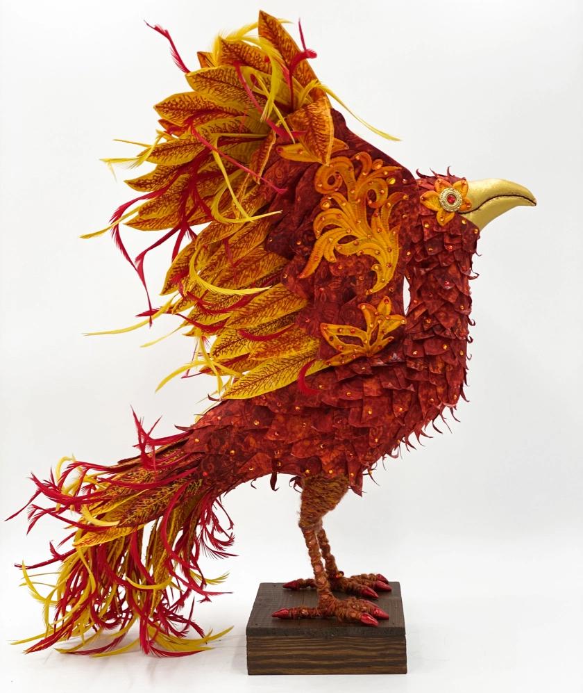 Phoenix on a stand created using quilted fabrics and techniques