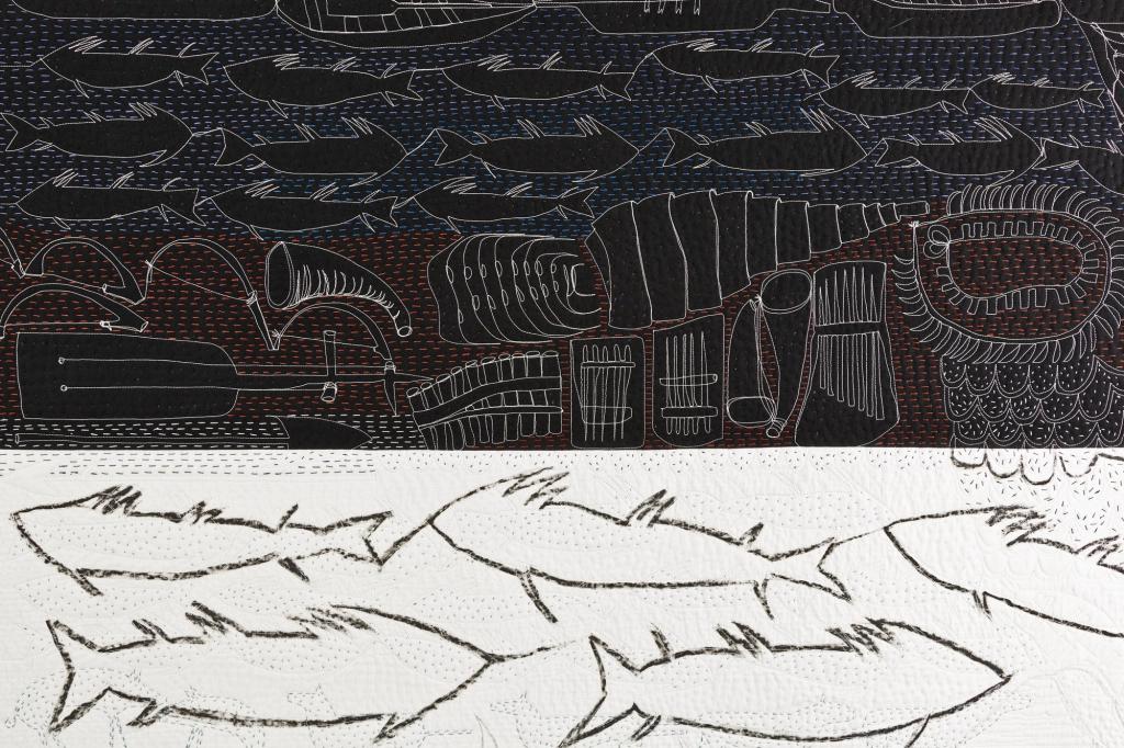 Re-told Stories: Pitt Rivers Legacy by Pauline Burbidge: Quilt in two halves one black with fish and marine shapes in white lines, the other white with fish depicted in black lines