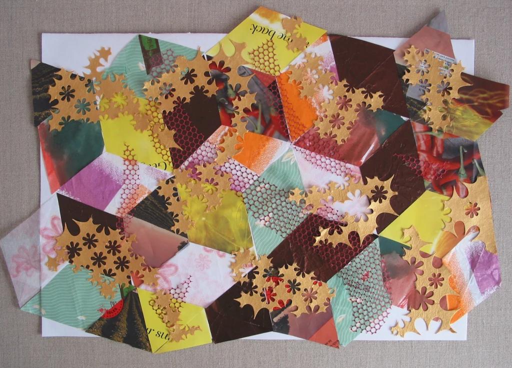 Patchwork pattern of triangles made from recycled coloured papers.