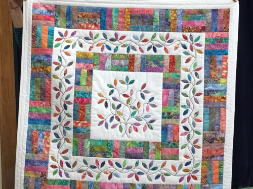 Quilt with mulitcoloured rectangles and vine leaf pattern