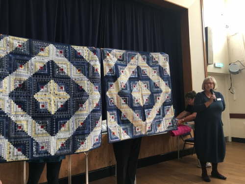 2 matching blue and white diamond patterned quilt