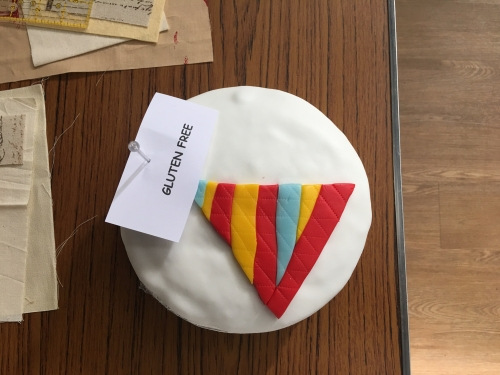 Birthday cake with party hat decoration and gluten free label